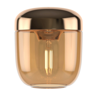 Acorn är en mässingsfärgad lampskärm med ett rökfärgat glas och en  innerdel i metall från Umage